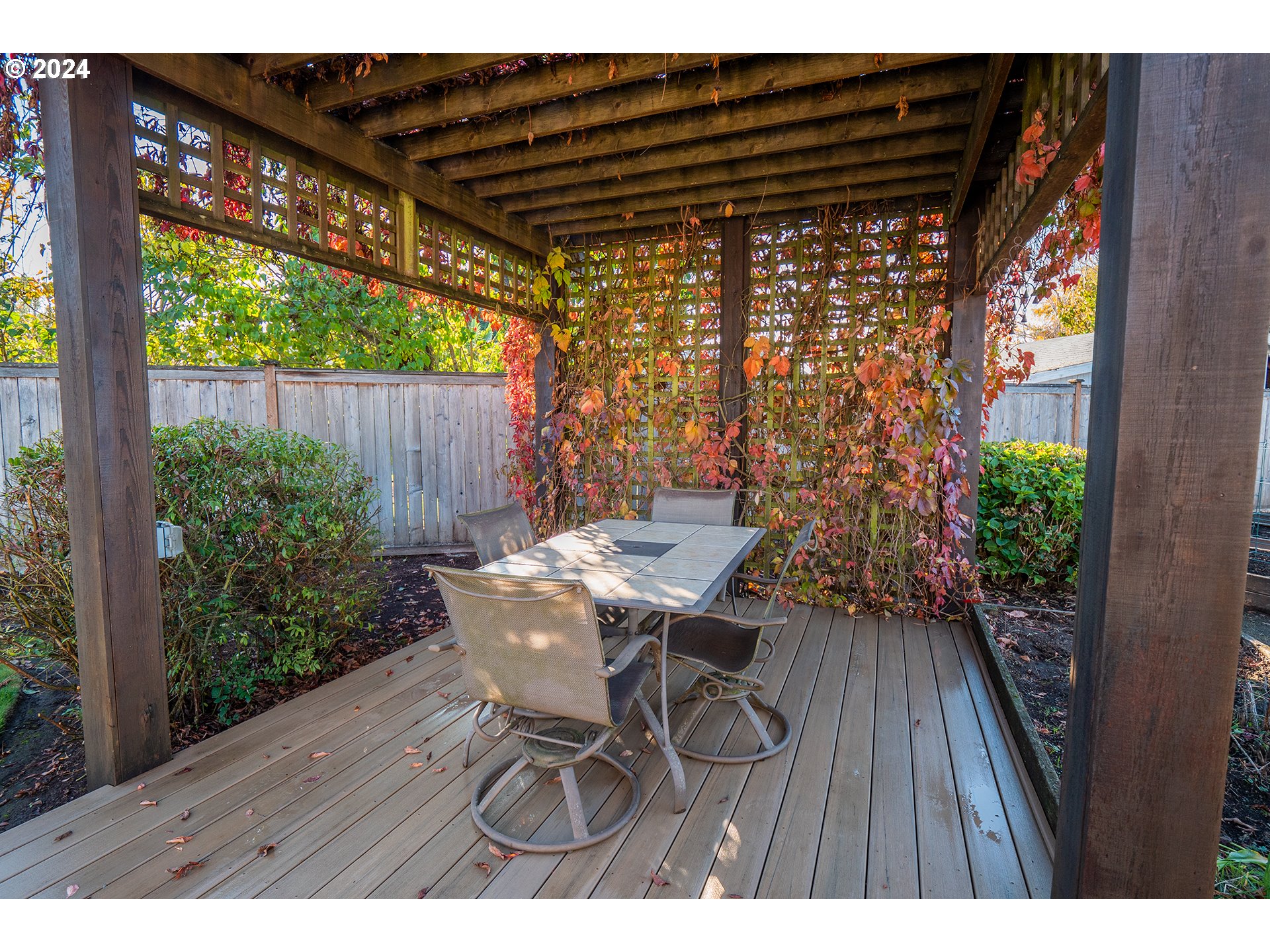 2556 Dumas Drive Springfield, OR 97477 - Photo 34 of 48 a view of a table and chairs in patio with wooden fence