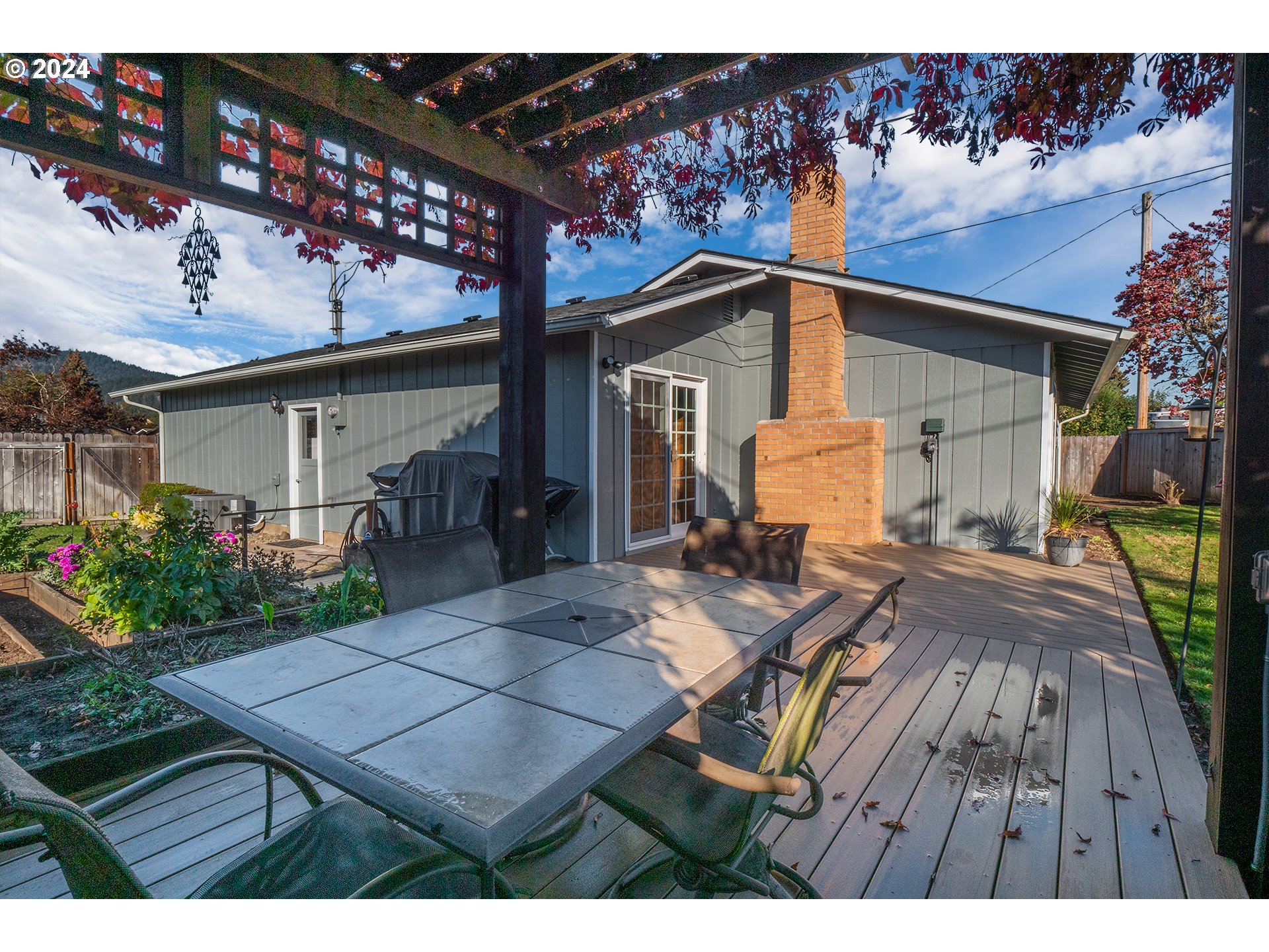 2556 Dumas Drive Springfield, OR 97477 - Photo 35 of 48 a view of a patio with table and chairs with potted plants