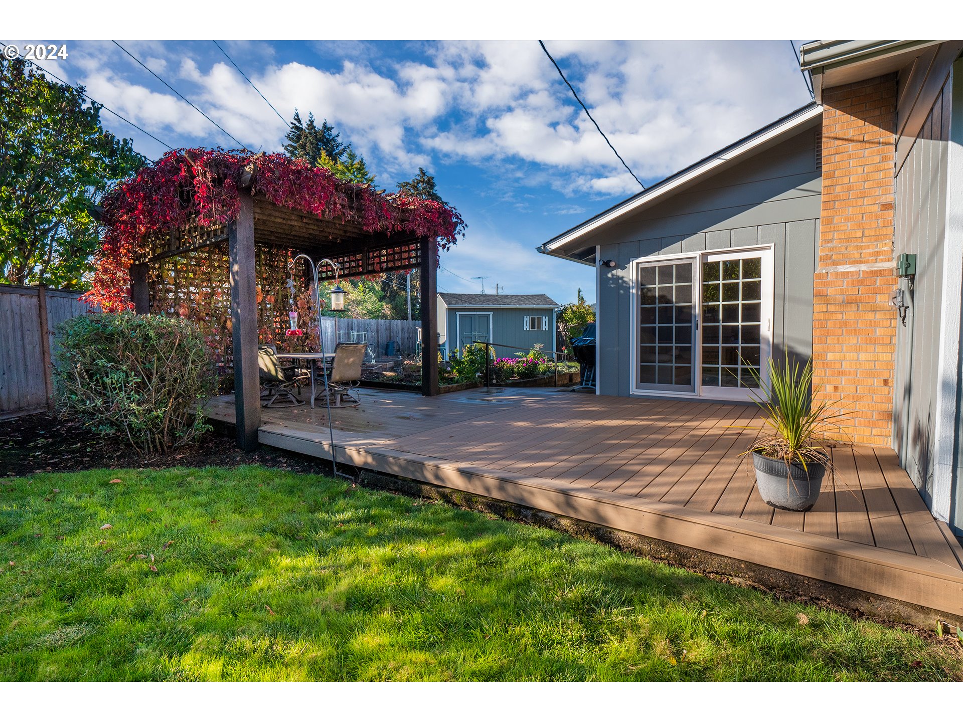2556 Dumas Drive Springfield, OR 97477 - Photo 37 of 48 a view of a house with a yard potted plants and a table