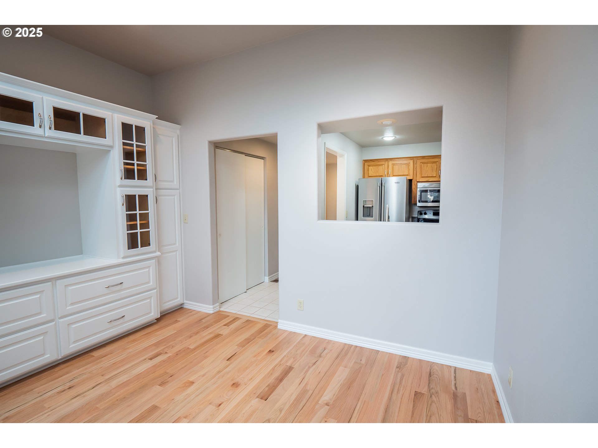 2556 Dumas Drive Springfield, OR 97477 - Photo 4 of 48 a view of an empty room with wooden floor and a window