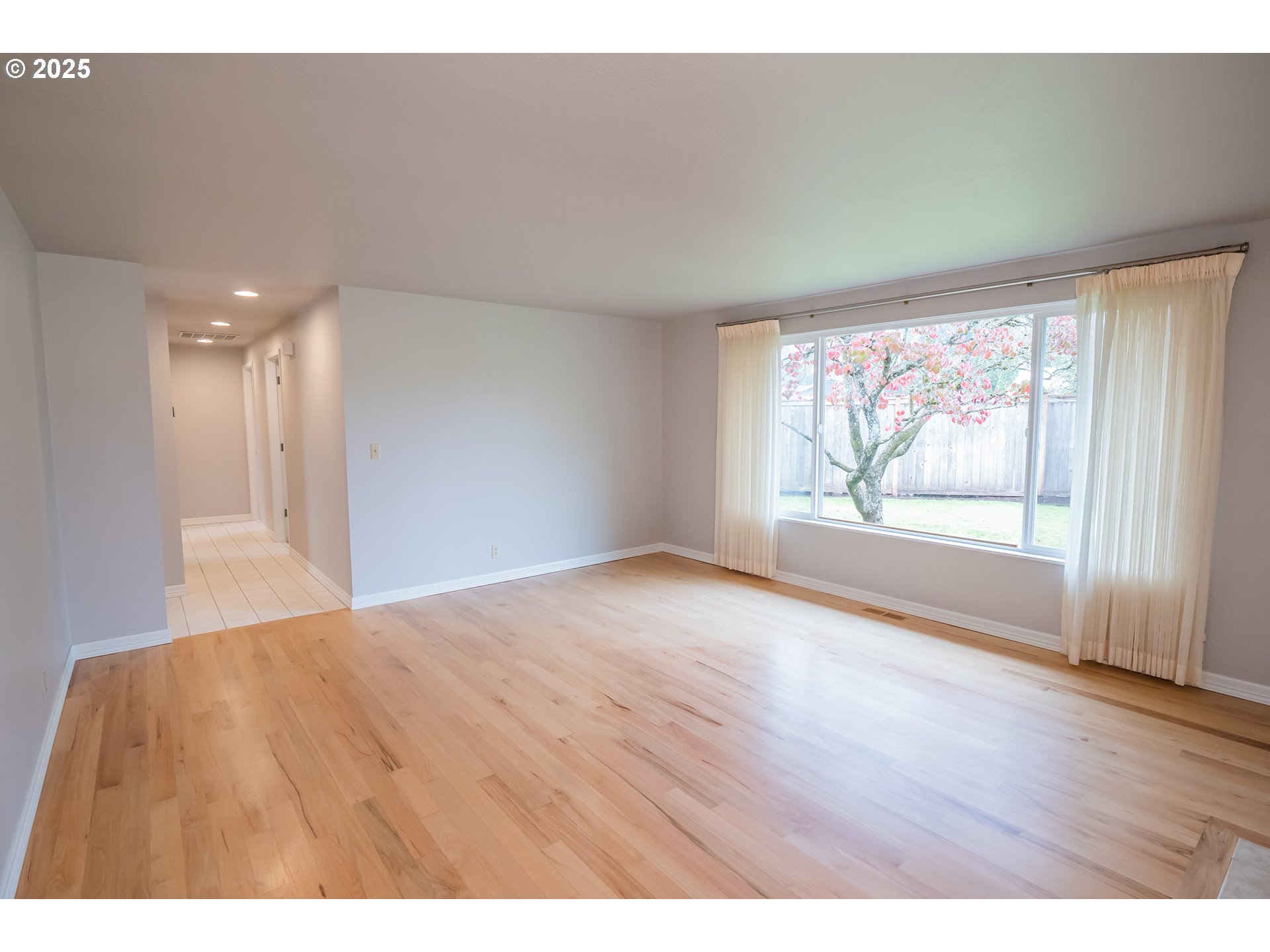 2556 Dumas Drive Springfield, OR 97477 - Photo 8 of 48 a view of an empty room with wooden floor and a window