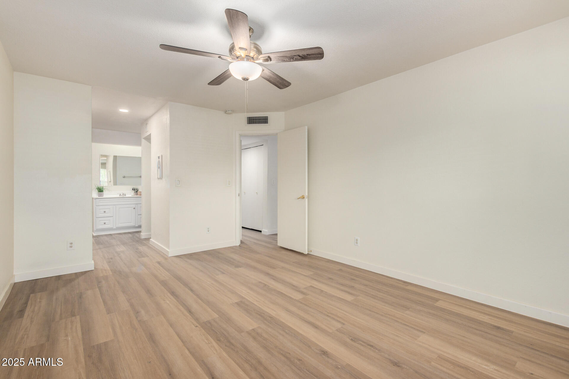 700 East Mesquite Circle, Unit L107 Tempe, AZ 85288 - Photo 11 of 26 a view of an empty room with wooden floor
