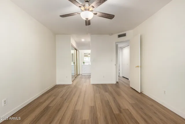 a bathroom with a sink a toilet and a large mirror