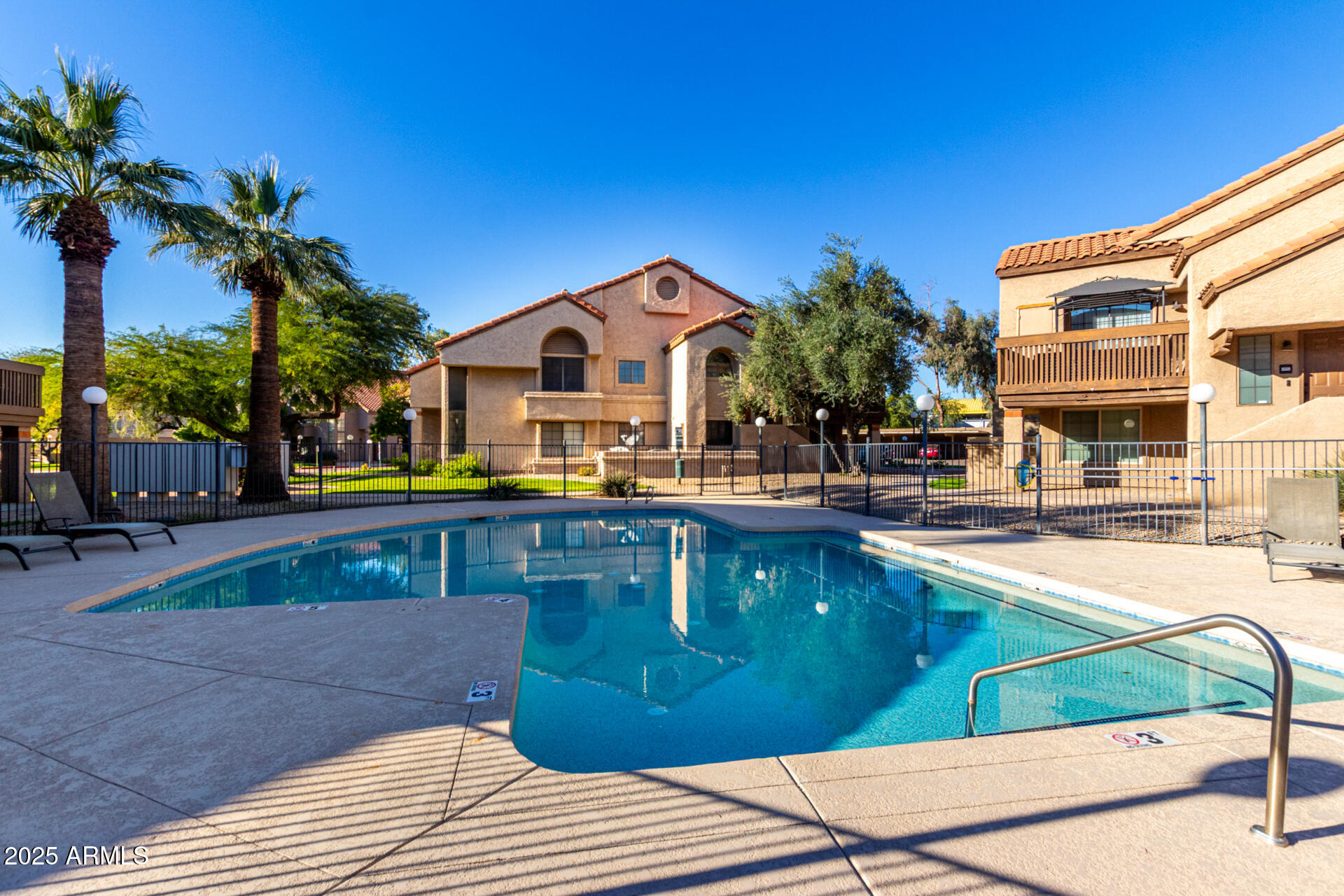 700 East Mesquite Circle, Unit L107 Tempe, AZ 85288 - Photo 23 of 26 a view of a house with a swimming pool