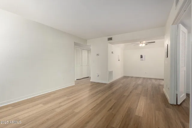 a view of a kitchen with wooden floor and a ceiling fan