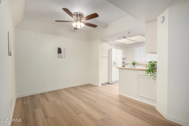 a kitchen with a refrigerator a sink a stove and white cabinets