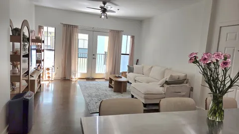 a living room with furniture and a floor to ceiling window