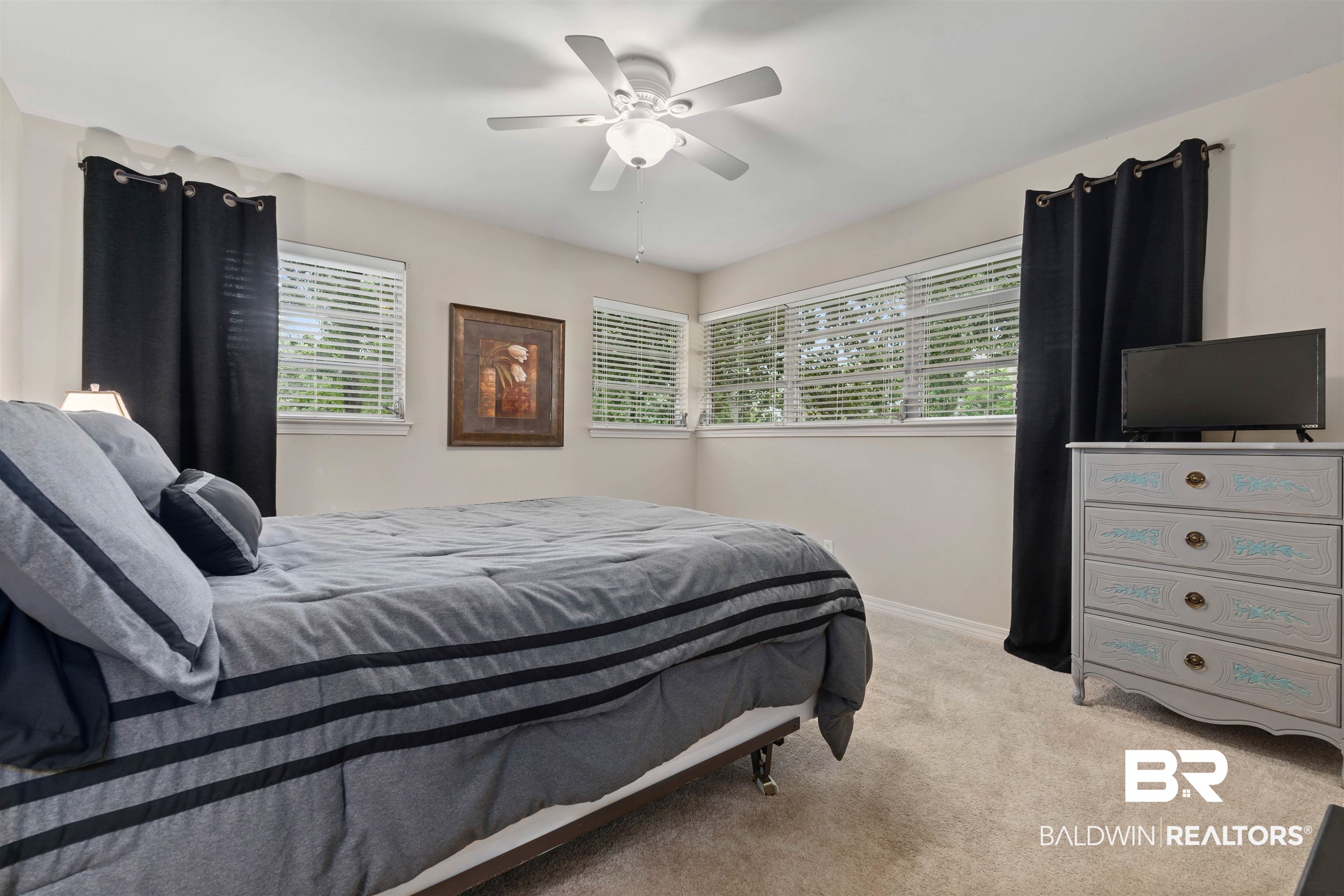 4051 East Canal Circle Mobile, AL 36619 - Photo 23 of 32 Bedroom with light carpet, multiple windows, and ceiling fan