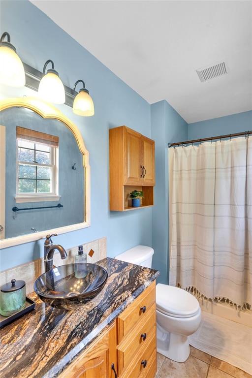 152 Cupps Road Renfrew, PA 16053 - Photo 29 of 43 a bathroom with a granite countertop toilet sink and mirror
