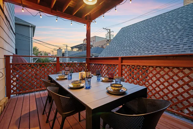 a outdoor dining space with furniture and wooden floor