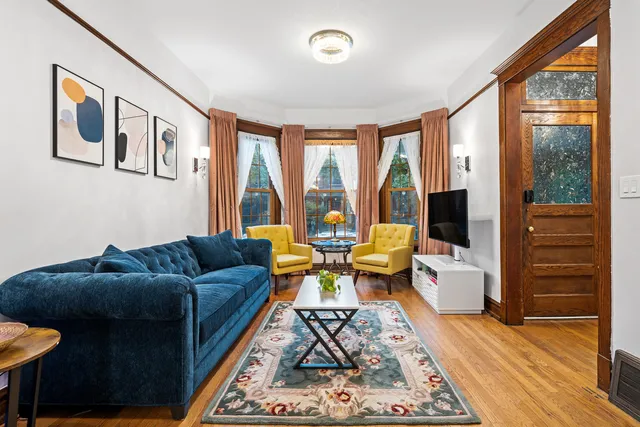 a living room with furniture and large windows