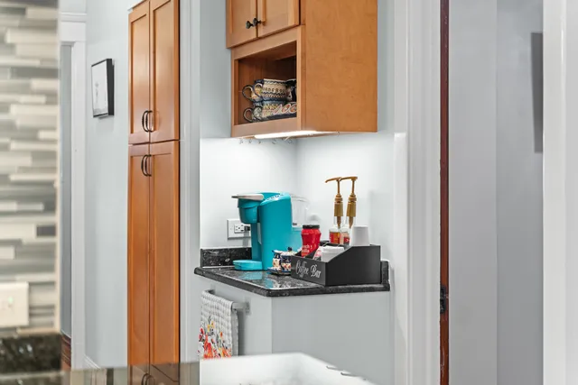 a kitchen with stainless steel appliances granite countertop a sink and cabinets