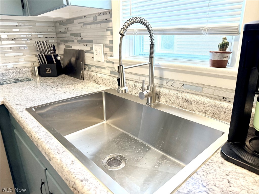 32125 Densmore Road Willowick, OH 44095 - Photo 9 of 23 Stainless steel single basin sink with a gooseneck faucet
