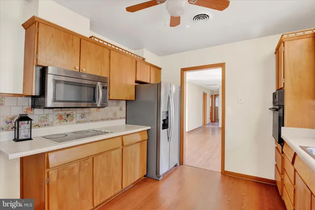 a kitchen with a sink stove and refrigerator