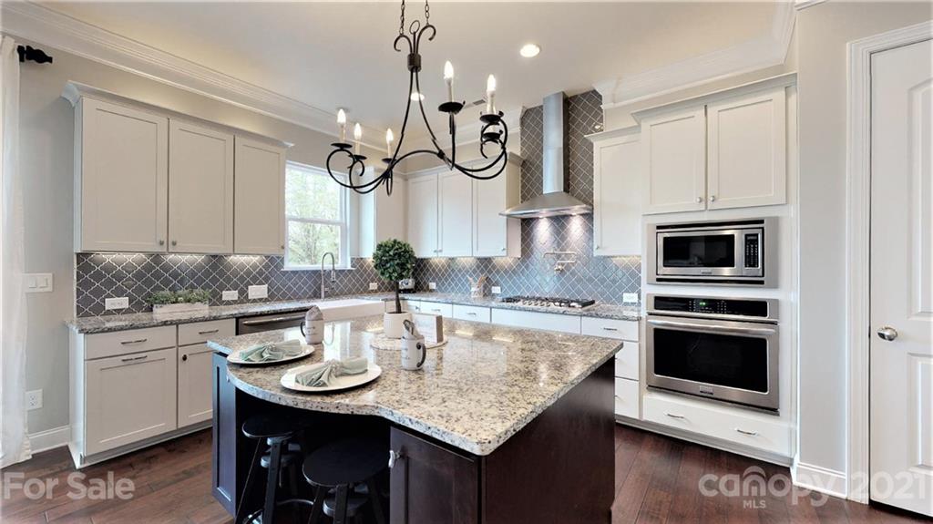 1000 Fallondale Road Waxhaw, NC 28173 - Photo 12 of 48 a kitchen with a sink stainless steel appliances and chandelier