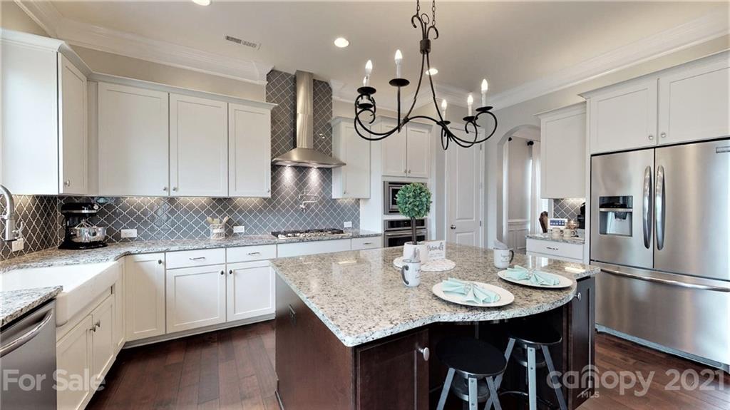 1000 Fallondale Road Waxhaw, NC 28173 - Photo 15 of 48 a kitchen with stainless steel appliances granite countertop a sink a stove a refrigerator and island with wooden floor
