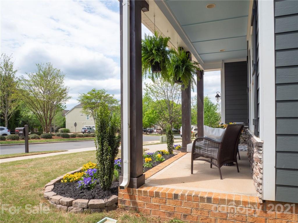 1000 Fallondale Road Waxhaw, NC 28173 - Photo 3 of 48 a view of a patio with table and chairs potted plants and palm tree