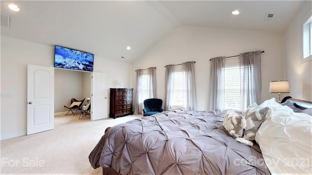 1000 Fallondale Road Waxhaw, NC 28173 - Photo 29 of 48 a bedroom with a bed and a chandelier