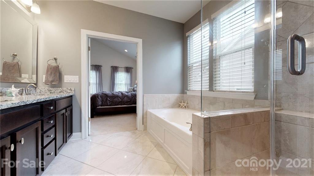 1000 Fallondale Road Waxhaw, NC 28173 - Photo 30 of 48 a en suite bathroom with a tub double vanity and a mirror