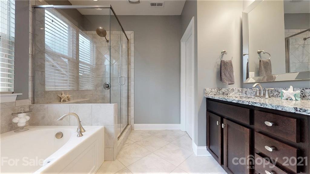 1000 Fallondale Road Waxhaw, NC 28173 - Photo 31 of 48 a bathroom with a tub sink and mirror