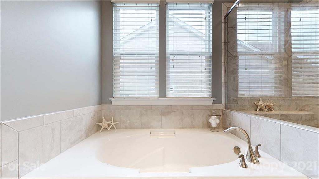 1000 Fallondale Road Waxhaw, NC 28173 - Photo 32 of 48 a white bath tub sitting in a bathroom next to a window