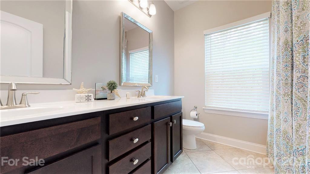 1000 Fallondale Road Waxhaw, NC 28173 - Photo 39 of 48 a bathroom with a double vanity sink toilet and a mirror