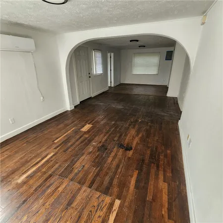 a view of a small space with wooden floor and staircase