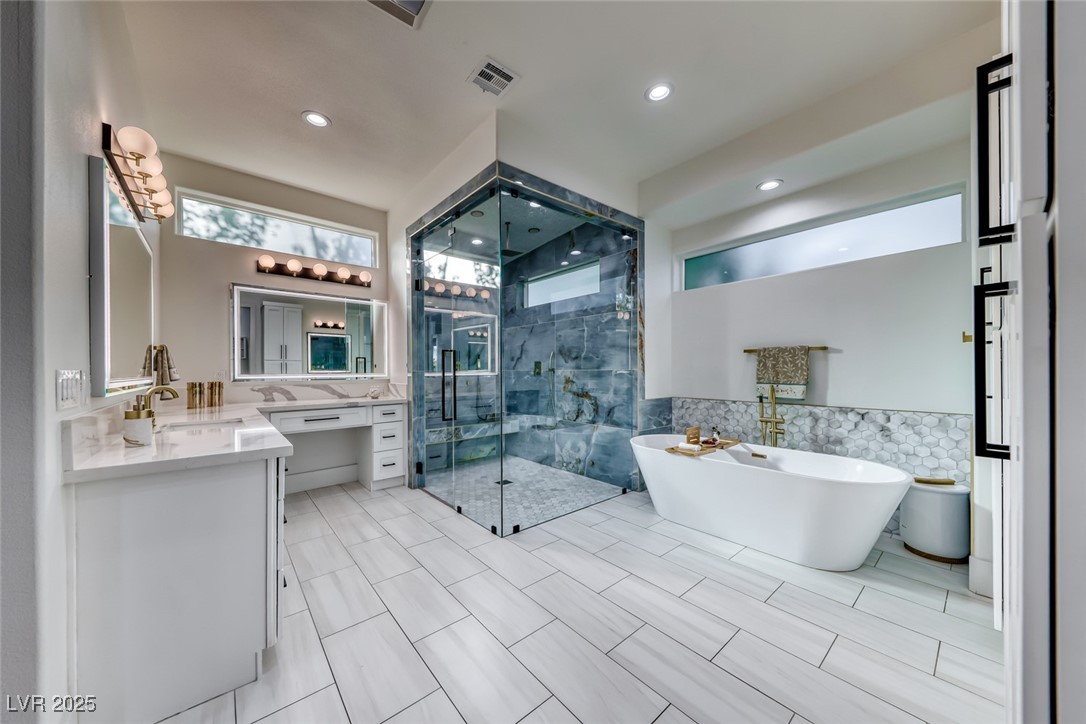 2309 Prometheus Court Henderson, NV 89074 - Photo 31 of 86 Full bathroom with vanity, tile walls, a freestanding tub, a stall shower, and recessed lighting