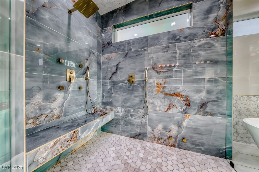 2309 Prometheus Court Henderson, NV 89074 - Photo 32 of 86 Bathroom with tile walls, a marble finish shower, a freestanding bath, and tile patterned floors