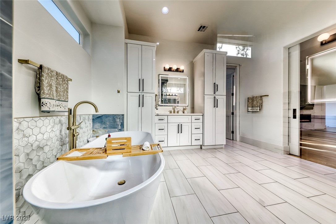2309 Prometheus Court Henderson, NV 89074 - Photo 33 of 86 Full bath featuring vanity, a freestanding tub, wood finish floors, and recessed lighting