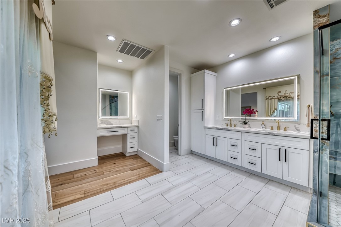 2309 Prometheus Court Henderson, NV 89074 - Photo 38 of 86 Full bathroom featuring double vanity, a shower stall, recessed lighting, and light wood-type flooring