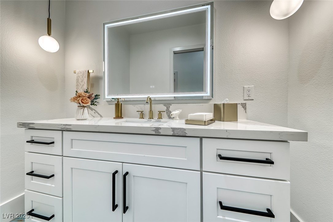 2309 Prometheus Court Henderson, NV 89074 - Photo 48 of 86 Bathroom featuring a textured wall and vanity
