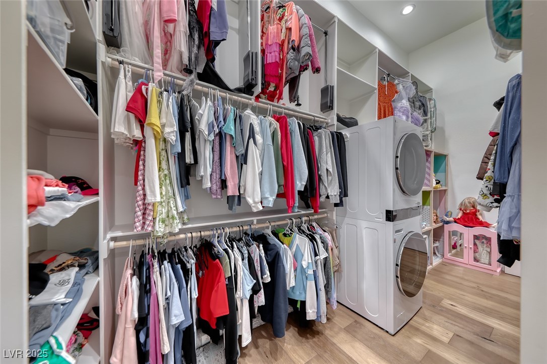 2309 Prometheus Court Henderson, NV 89074 - Photo 54 of 86 Walk in closet with light wood finished floors and stacked washer and clothes dryer