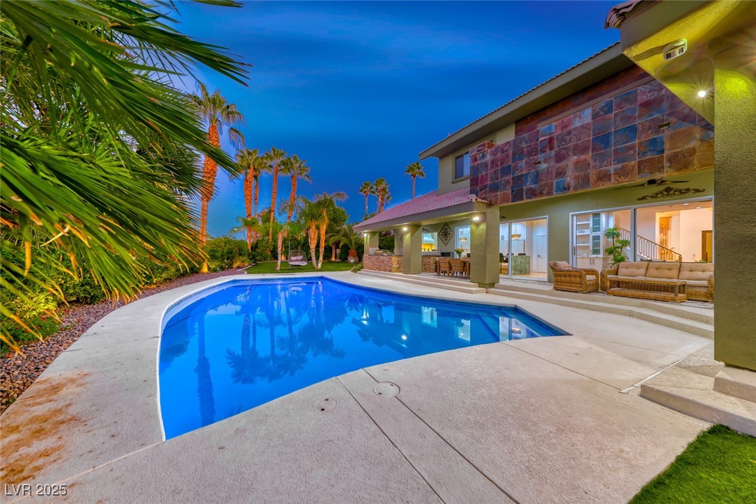2309 Prometheus Court Henderson, NV 89074 - Photo 69 of 86 Pool at twilight with a patio, an outdoor pool, an outdoor hangout area, and ceiling fan