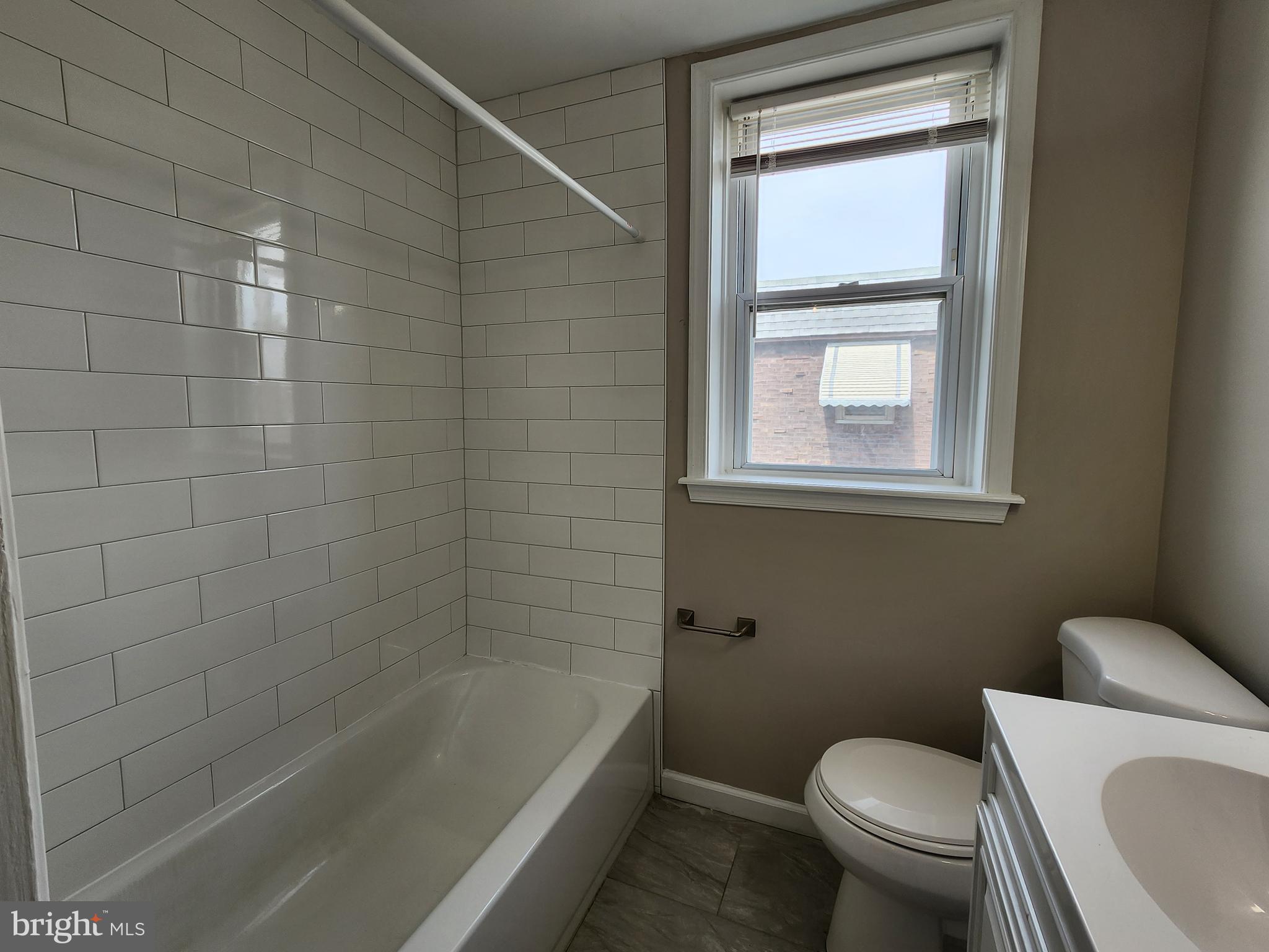 201 Westbridge Road Glenolden, PA 19036 - Photo 14 of 24 a bath room with a toilet a bath tub and a shower
