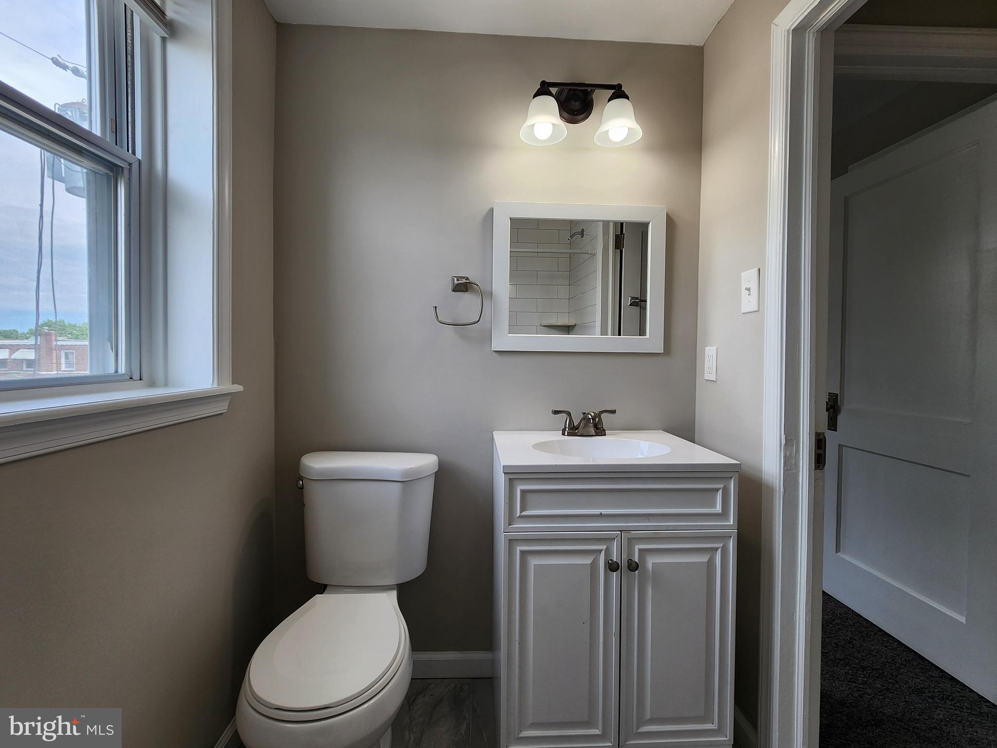 201 Westbridge Road Glenolden, PA 19036 - Photo 15 of 24 a bathroom with a toilet a sink a vanity and mirror