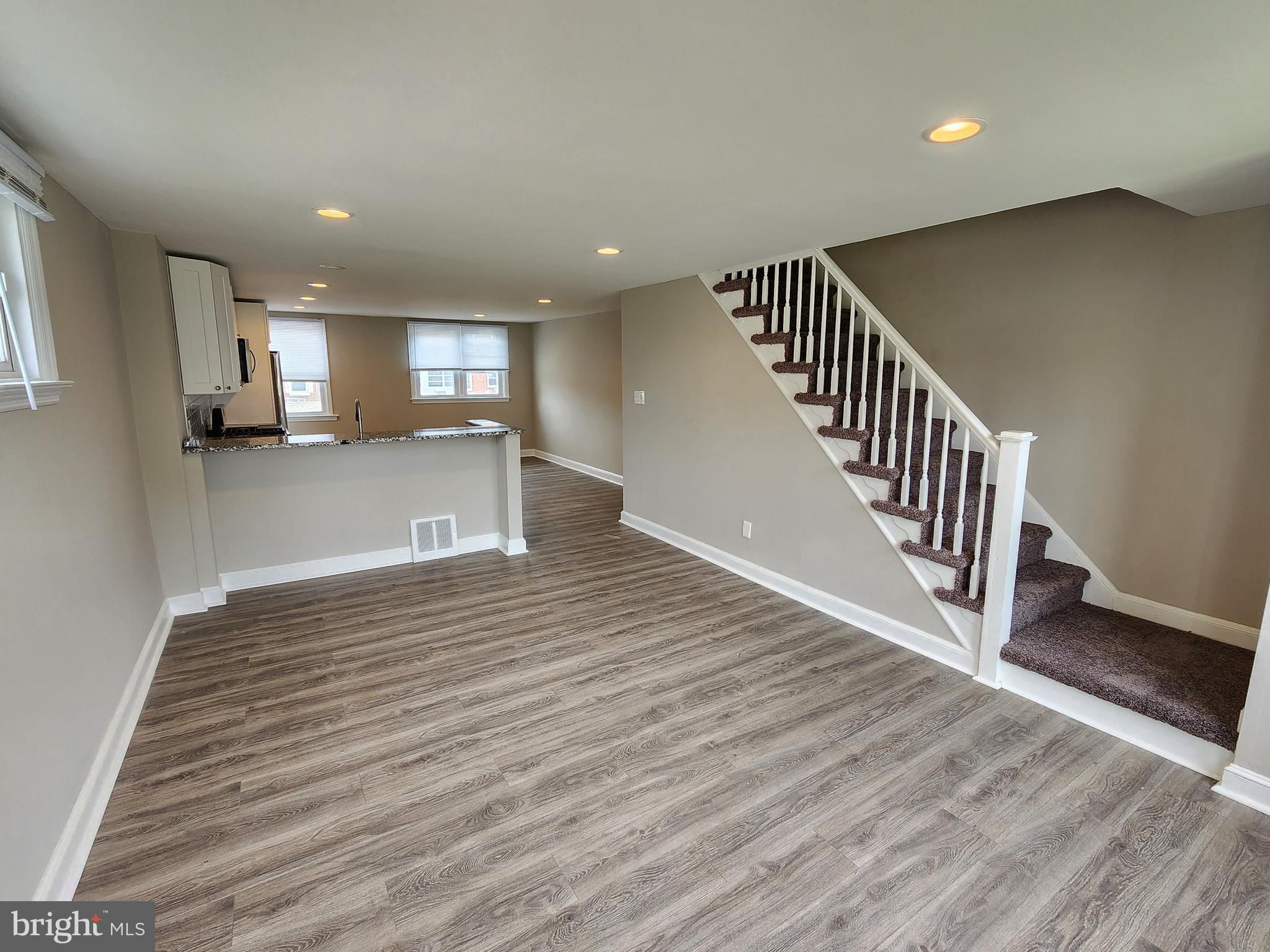 201 Westbridge Road Glenolden, PA 19036 - Photo 3 of 24 a view of a hallway with wooden floor and staircase