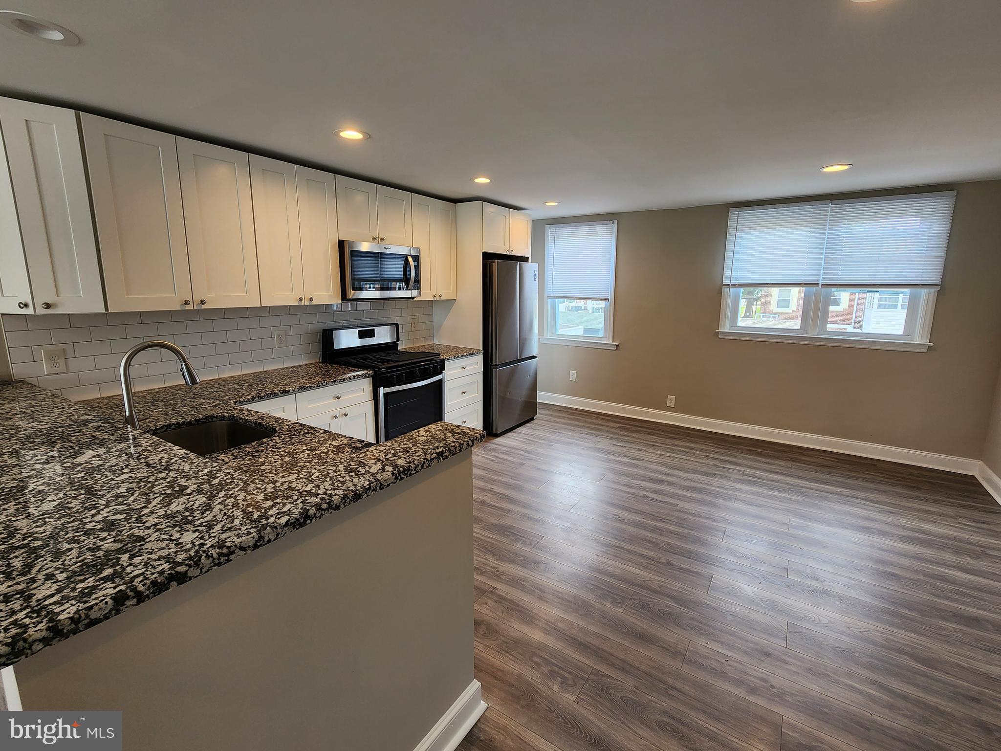 201 Westbridge Road Glenolden, PA 19036 - Photo 5 of 24 a kitchen with stainless steel appliances granite countertop a sink stove and cabinets