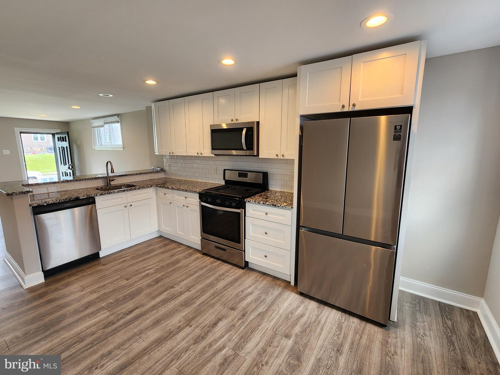 201 Westbridge Road Glenolden, PA 19036 - Photo 6 of 24 a kitchen with granite countertop a refrigerator stove top oven and sink