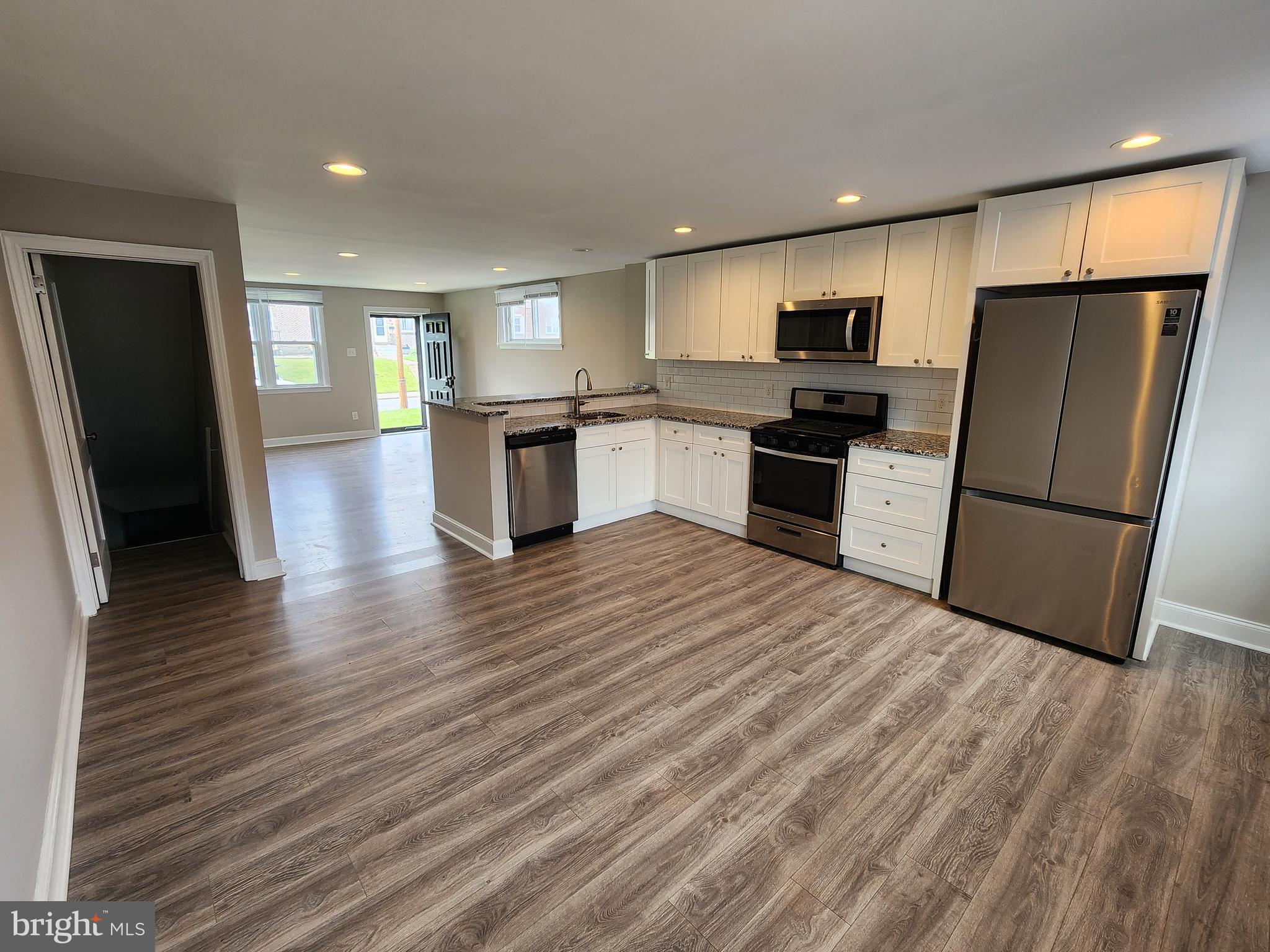 201 Westbridge Road Glenolden, PA 19036 - Photo 7 of 24 a kitchen with stainless steel appliances granite countertop a refrigerator stove top oven and sink