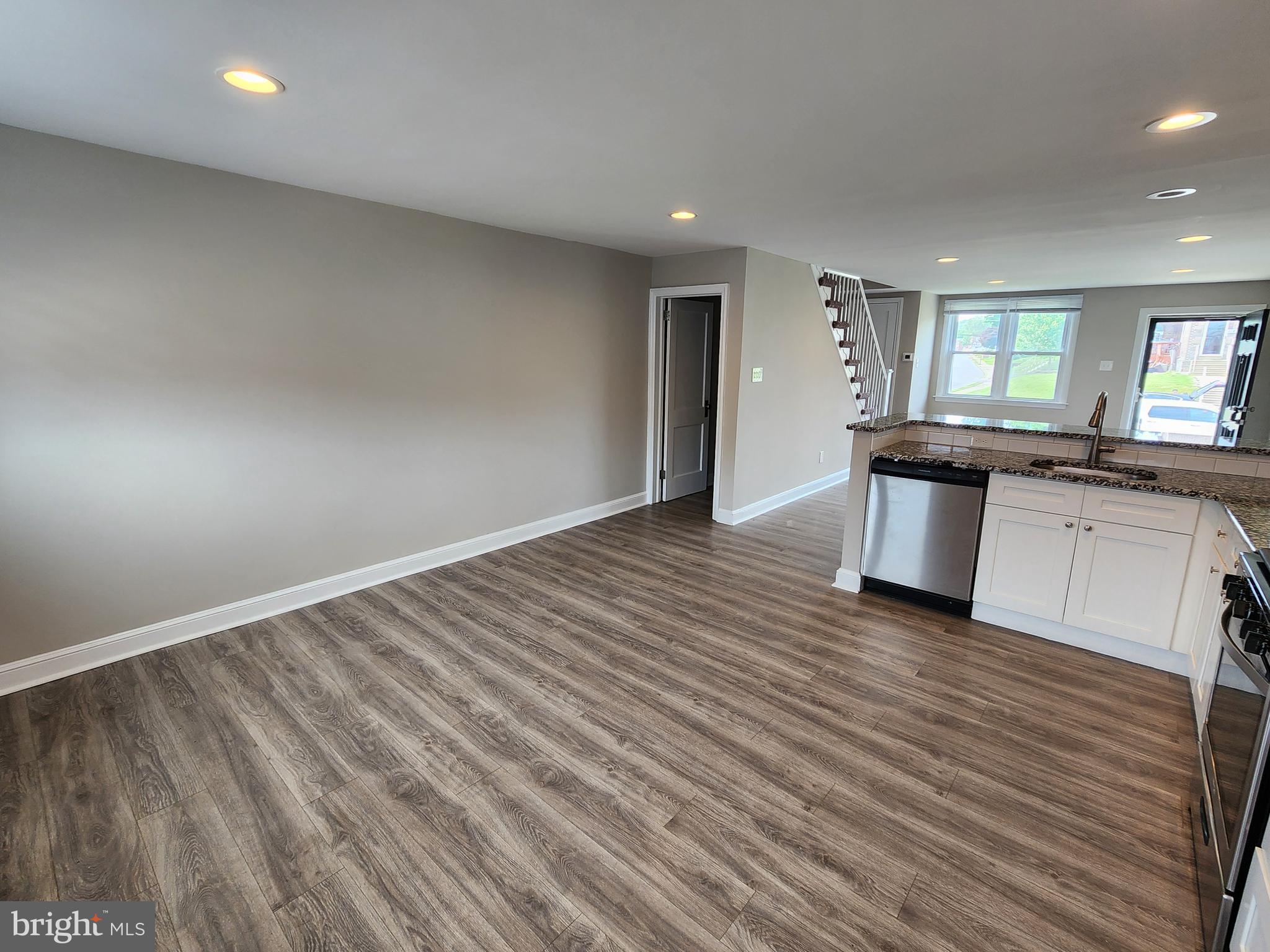 201 Westbridge Road Glenolden, PA 19036 - Photo 8 of 24 an empty room with wooden floor and windows