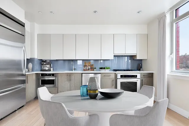 a kitchen with a refrigerator stove top oven and sink