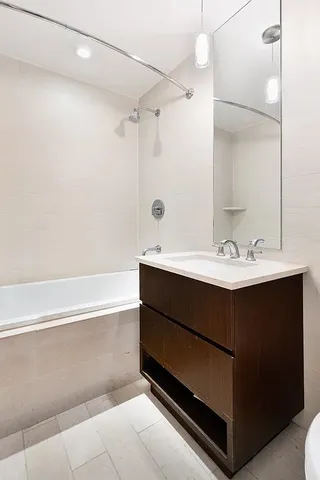 a bathroom with a sink vanity tub and shower
