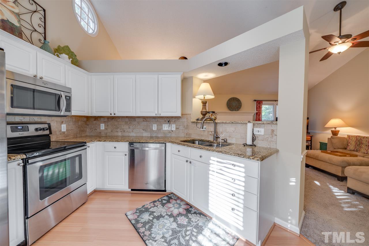 3617 Hopper Street Raleigh, NC 27616 - Photo 14 of 20 a kitchen with stainless steel appliances granite countertop a sink and a stove