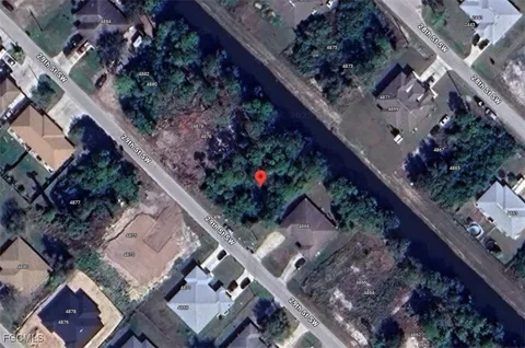 an aerial view of a residential apartment building with a yard