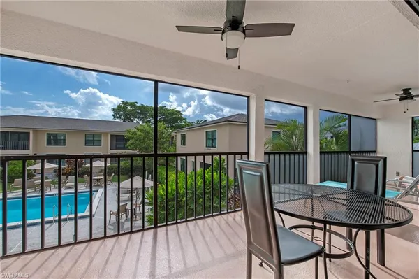 a view of a porch with furniture and wooden floor