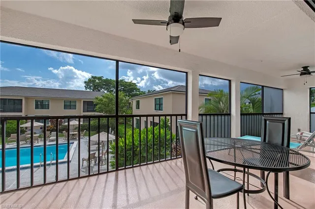 a view of a porch with furniture and wooden floor