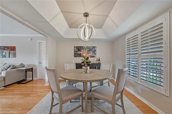 a view of a dining room with furniture window and wooden floor