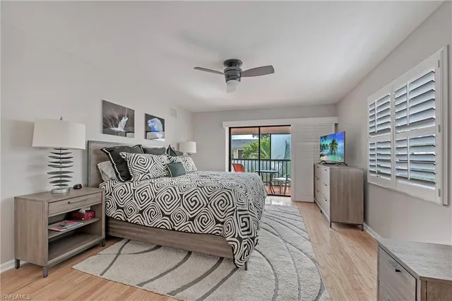 a bedroom with a bed and a large window