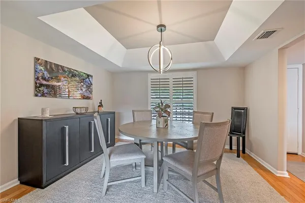 a view of a dining room with furniture window and wooden floor